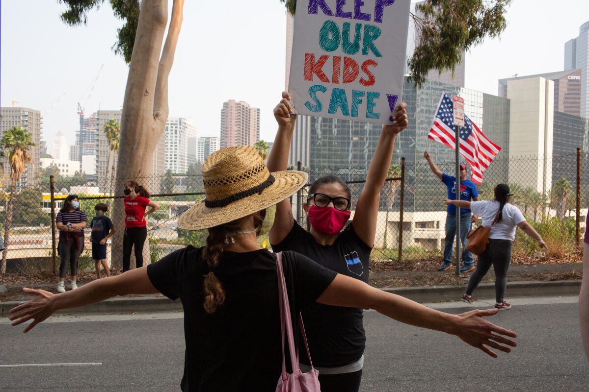 Protesters and counter-protesters rally outside the L.A. Unified School District on Tuesday.