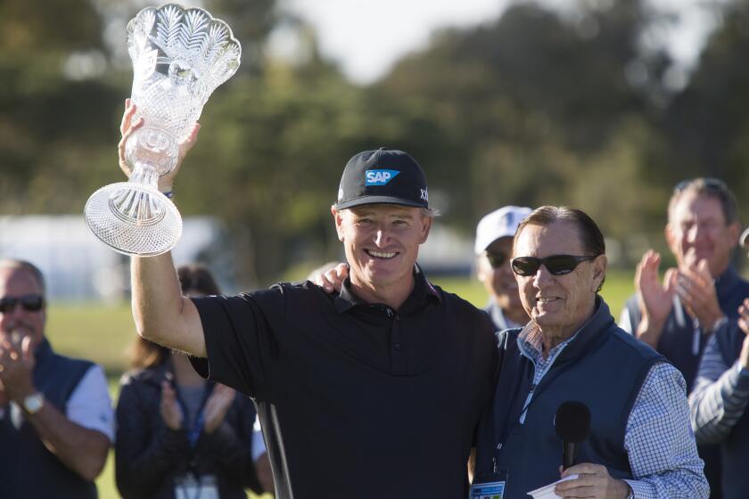 From left, Ernie Els poses for a photograph with Paul Folino after wining the Hoag Classic at the Newport Beach Country Club on Sunday, March 8, 2020. ///ADDITIONAL INFO: tn-dpt-sp-nb-hoag-classic-final-round-20200308 3/8/20 - Photo by DREW A. KELLEY, CONTRIBUTING PHOTOGRAPHER