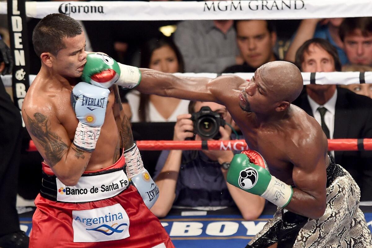 Floyd Mayweather Jr. lands a right to the face of Marcos Maidana during their world welterweight title fight on Saturday night at the MGM Grand Garden Arena in Las Vegas.