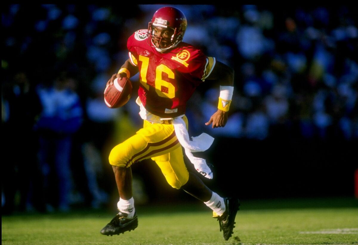 USC quarterback Rodney Peete runs with the ball against Michigan in the 1989 Rose Bowl.