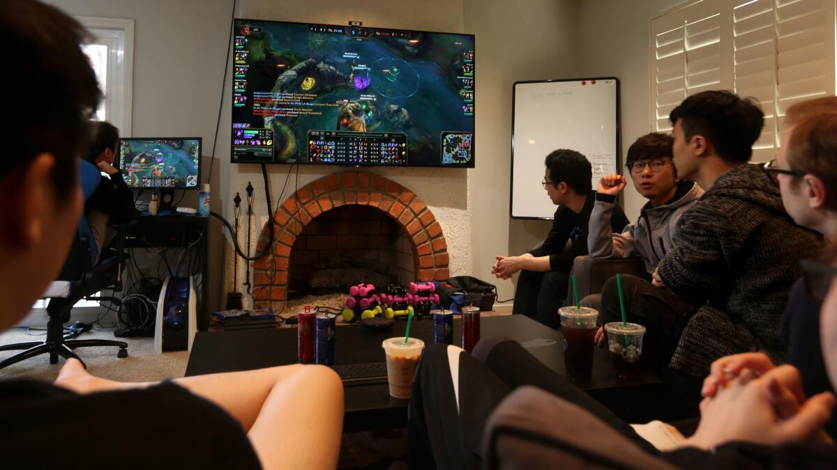Cloud9's "League of Legends" team goes over the replay of a recent online game at the house where they live and practice.