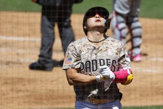 San Diego CA - May 12: San Diego Padres' Ha-Seong Kim reacts after getting hit on the wrist by a pitch against the Los Angeles Dodgers at Petco Park on Sunday, May 12, 2024 in San Diego, CA. (K.C. Alfred / The San Diego Union-Tribune)