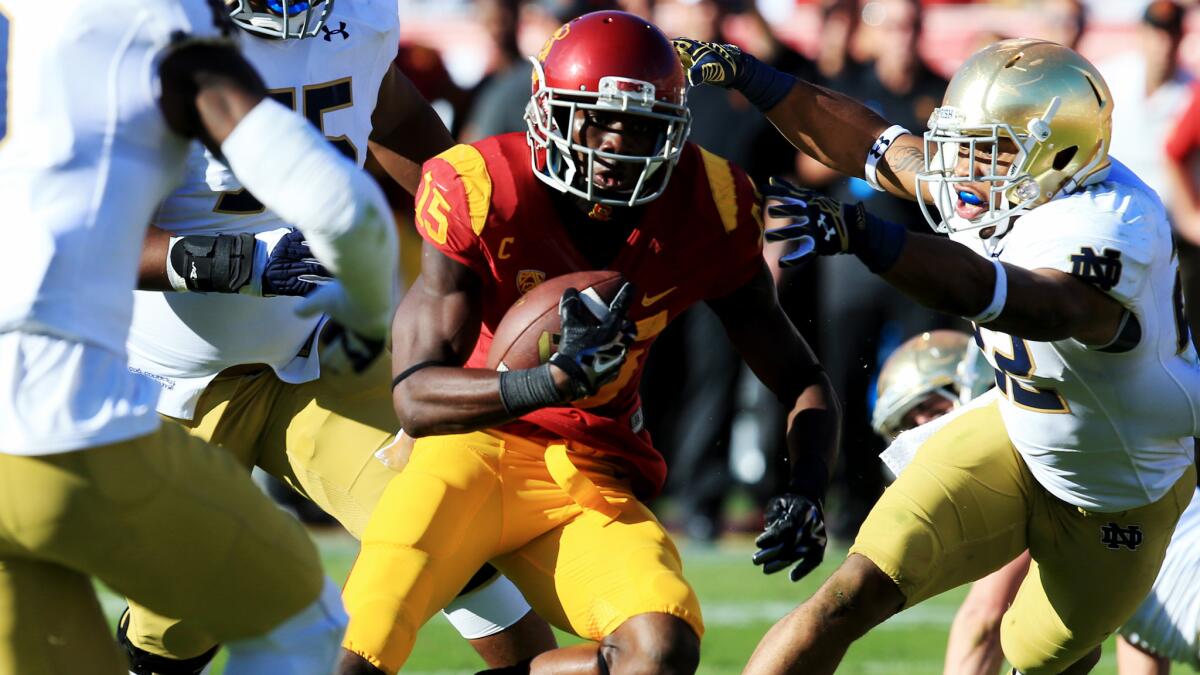 USC wide receiver Nelson Agholor sprints through the Notre Dame defense on his way to scoring a touchdown during the second quarter on Saturday.