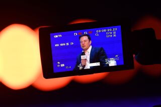 Elon Musk (R), Co-founder and CEO of Tesla, is seen on the screen of a video camera during the World Artificial Intelligence Conference (WAIC) in Shanghai on August 29, 2019. (Photo by HECTOR RETAMAL / AFP) (Photo credit should read HECTOR RETAMAL/AFP/Getty Images)