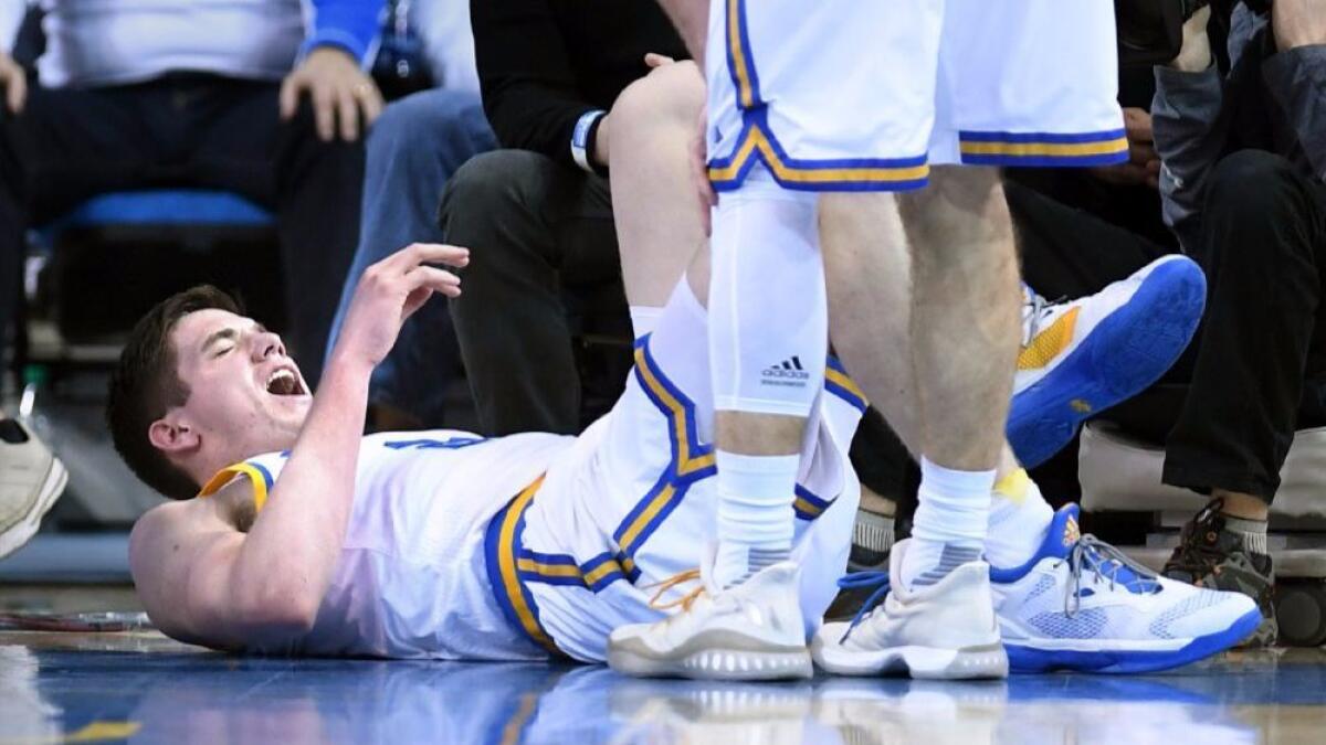 UCLA forward TJ Leaf grimaces in pain after injuring his ankle in the first half against Washington at Pauley Pavilion on March 1.