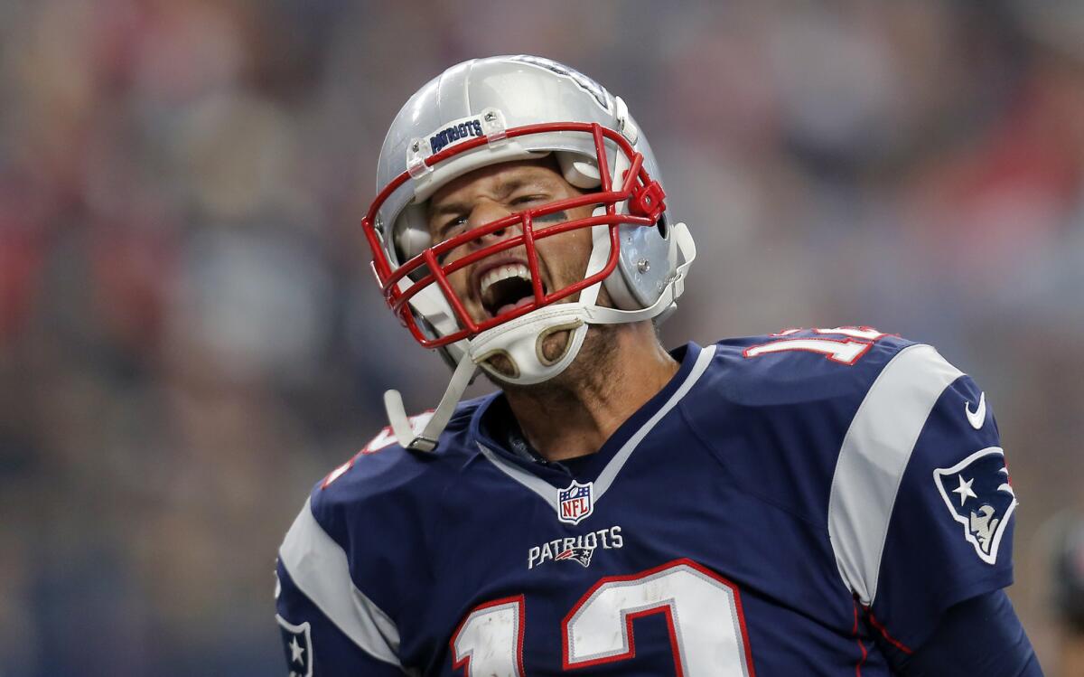 New England Patriots' Tom Brady celebrates after scoring on a 1-yard run against the Dallas Cowboys during a game in October.