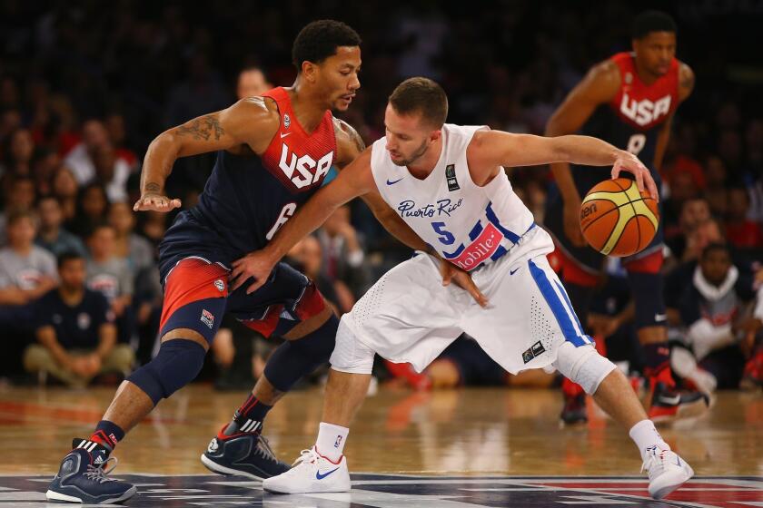 Derrick Rose guards Puerto Rico's J.J. Berea during the second half of an exhibition game in New York. The U.S. national team beat to Puerto Rico, 112-86.