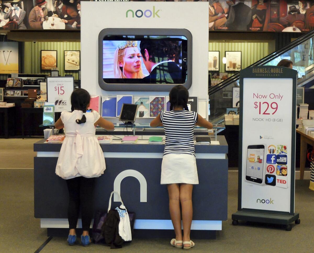 Customers look at Nook tablets at a Barnes & Noble store in Pineville, N.C., in June 2013.