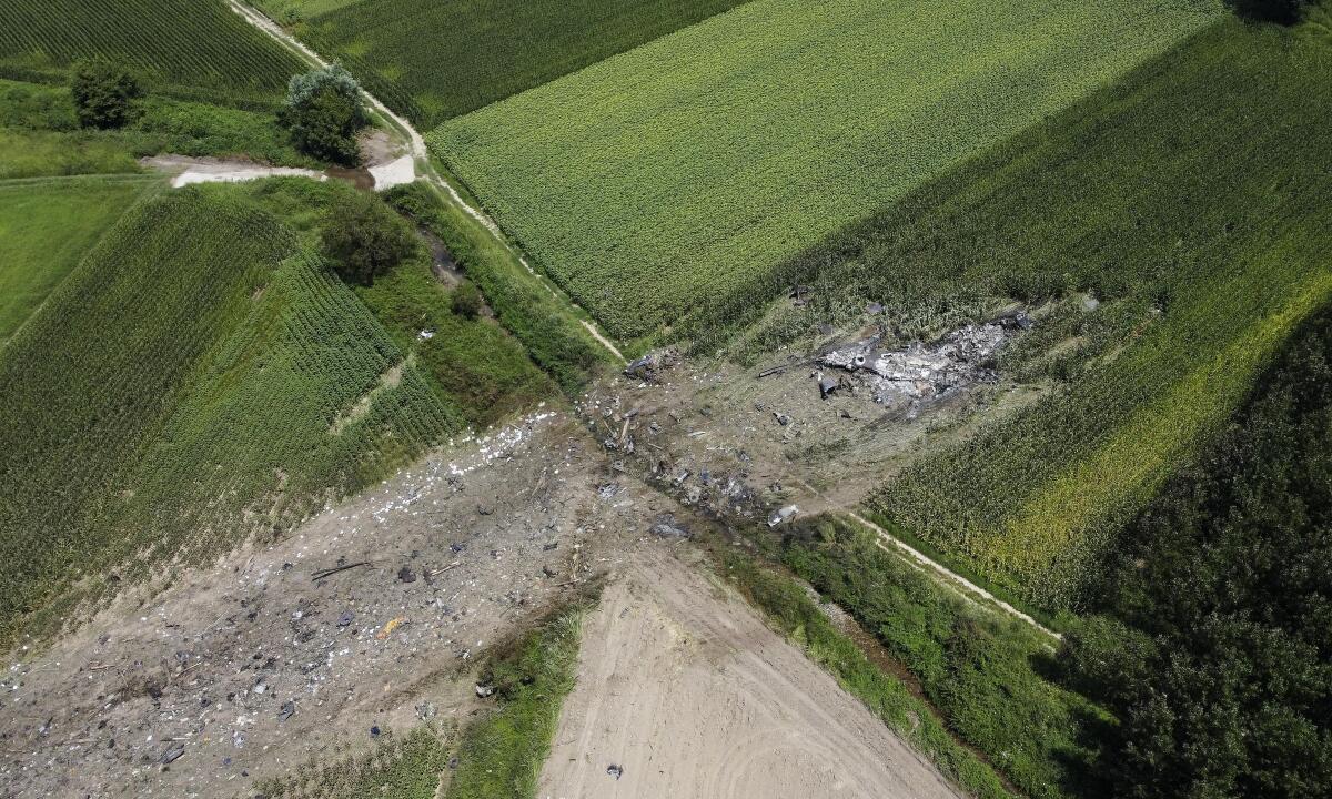 This drone photo shows the site where the AN-12 cargo plane crashed, in Palaiochori village near the town of Kavala, in northern Greece, Sunday, July 17, 2022. Experts are poised to investigate the site of a plane crash in northern Greece to determine whether any dangerous chemicals or explosive cargo remains. (AP Photo/Giannis Papanikos)