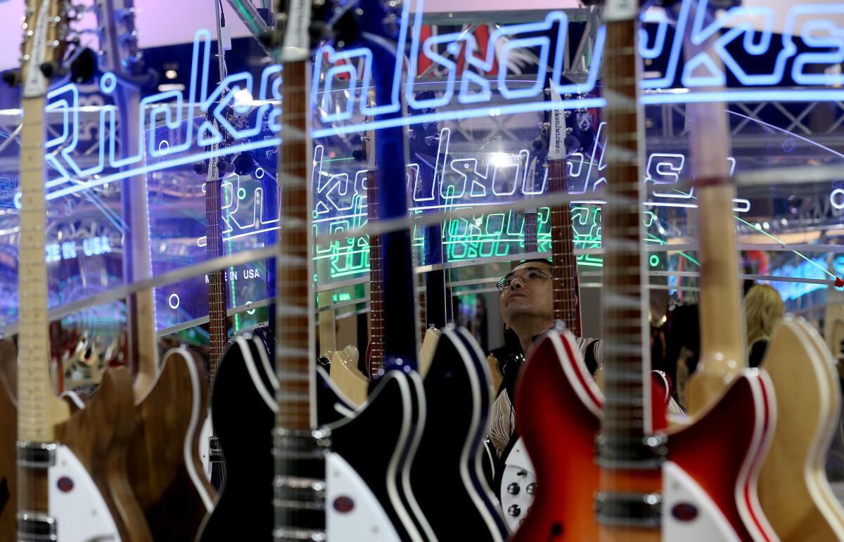 A man checks out the display at the Rickenbacker Guitars booth during the annual National Assn. of Music Merchants show at the Anaheim Convention Center.