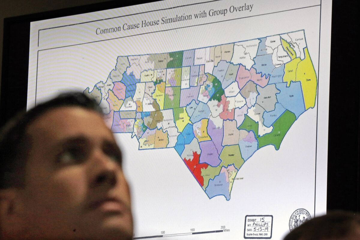 FILE - In this Monday, July 15, 2019 file photo, a state districts map is shown as a three-judge panel of the Wake County Superior Court presides over the trial of Common Cause, et al. v. Lewis, et al, in Raleigh, N.C. Fresh off sweeping electoral victories a decade ago, governors and lawmakers in several states used new census data to redraw voting districts for Congress and state legislatures that were intended to help their party remain in power for years to come. Those efforts largely paid off, particularly for Republicans. An Associated Press analysis designed to detect the effects of gerrymandering shows that Republicans enjoyed a greater political advantage in more states over the past decade than either party had over the past 50 years. (AP Photo/Gerry Broome, File)