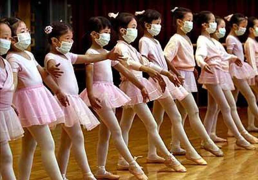 Children taking a ballet class in Hong Kong in 2003 wore masks to protect themselves from severe acute respiratory syndrome, or SARS.