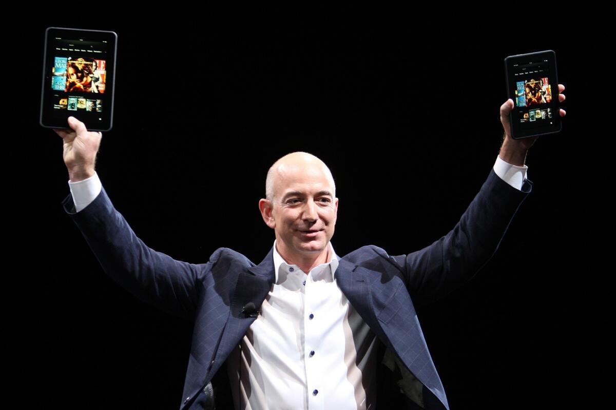 Amazon CEO Jeff Bezos with two Kindle Fire HD tablets.