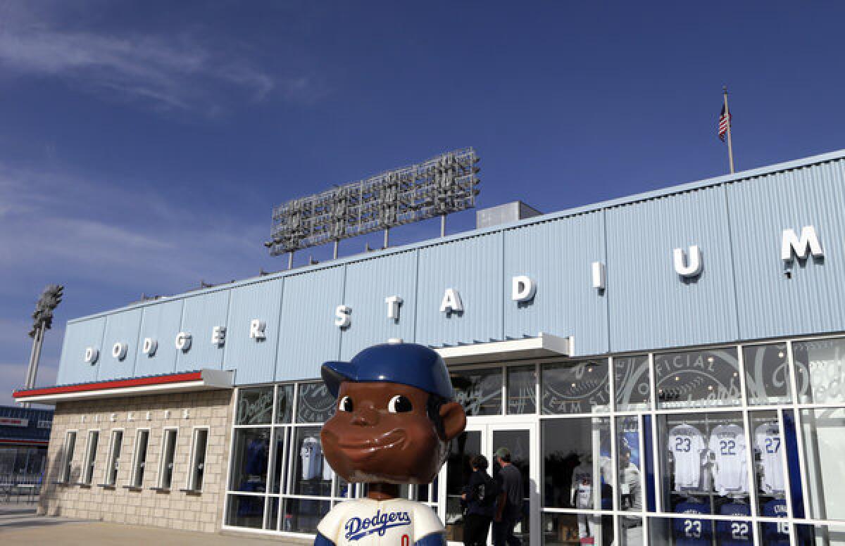 A bobble-head sculpture stands in front of a gift store at an entrance to the newly renovated Dodger Stadium.