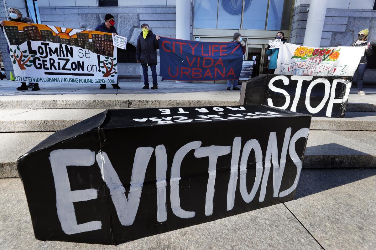 Tenants' rights advocates demonstrate with signs in front of the Edward W. Brooke Courthouse in Boston. 