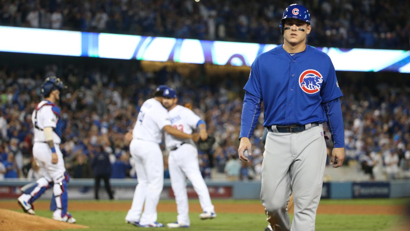 Chicago Cubs first baseman Anthony Rizzo (44) walks off as Dodgers celebrate their win at Game 3 of the NLCS.