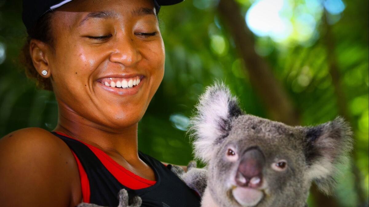 Tennis champion Naomi Osaka holds a koala named Sprocket during a December visit to the Lone Pine Koala Sanctuary in Brisbane, Australia, one of the top attractions in that city. A Fiji Airways sale includes Brisbane among the round-trip fares for $699.