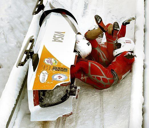 Team Canada 1 with pilot Lyndon Rush, top, slides in the break lane after crashing behind the finish line in fourth place in the FIBT Four-Man Bobsled World Cup competition in Altenberg, Germany. No one was injured.