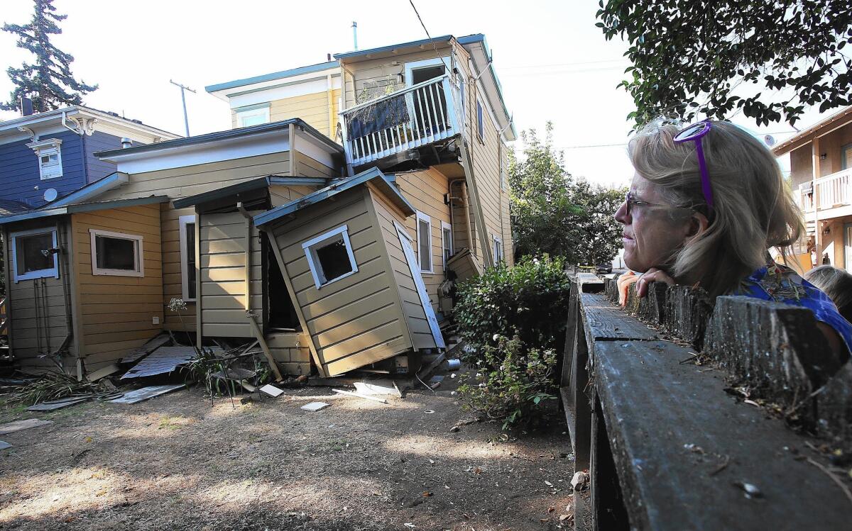 Vickie Katsubayashi checks out a red-tagged home near downtown Napa the day after the earthquake.