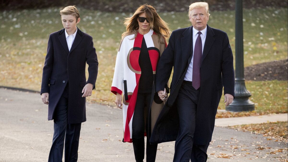 President Trump, accompanied by First Lady Melania Trump and their son, Barron, walks toward Marine One on the South Lawn of the White House in Washington on Nov. 20.