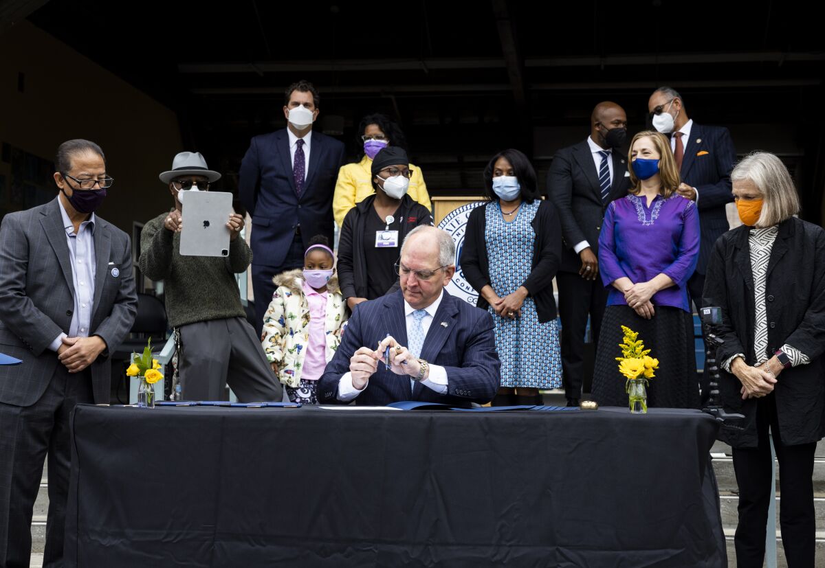 Gov. John Bel Edwards pardons Homer Plessy during the Posthumous Pardoning Ceremony for Homer Plessy at the New Orleans Center for Creative Arts in New Orleans, Wednesday, Jan. 5, 2022. Louisiana’s governor on Wednesday posthumously pardoned Plessy, the Black man whose arrest for refusing to leave a whites-only railroad car in 1892 led to the Supreme Court ruling that cemented “separate but equal” into U.S. law for half a century. (Sophia Germer/The Advocate via AP)