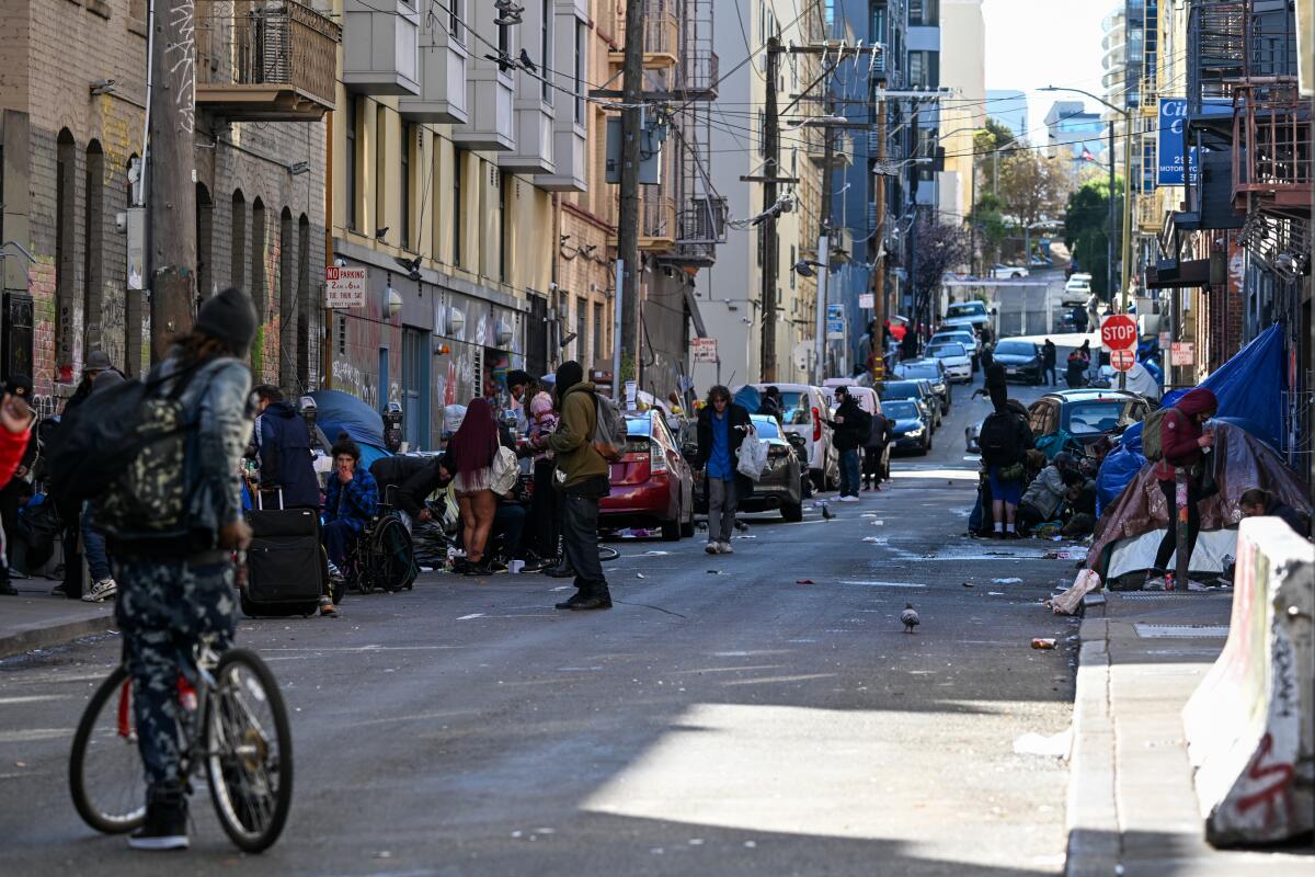 Homeless people and makeshift shelters line a street in San Francisco. 