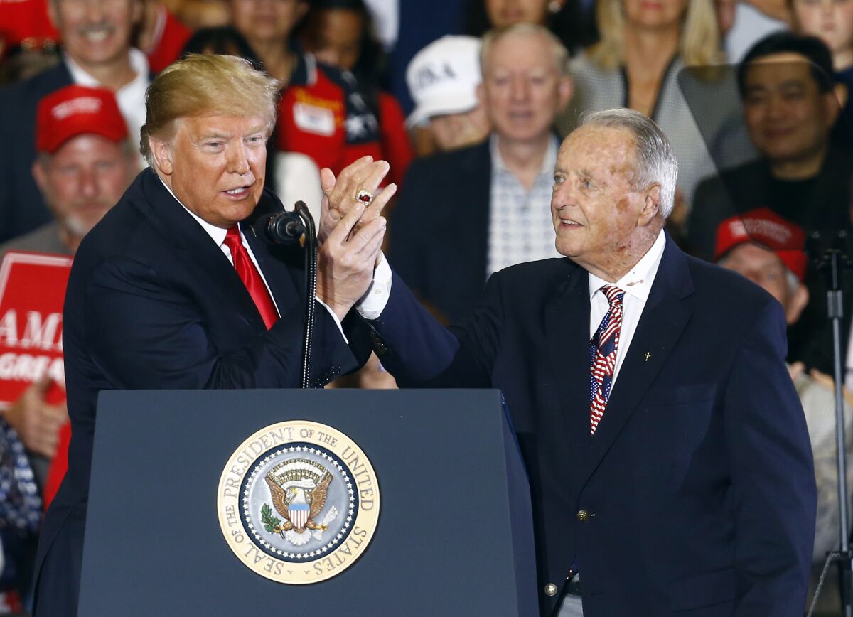 At a 2018 rally, President Trump points to Bobby Bowden's national championship ring.