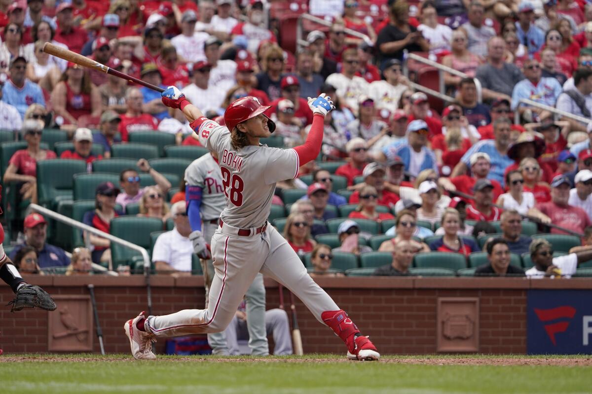 Philadelphia Phillies' Alec Bohm watches his sacrifice fly to score Mickey Moniak during the ninth inning of a baseball game against the St. Louis Cardinals Saturday, July 9, 2022, in St. Louis. (AP Photo/Jeff Roberson)