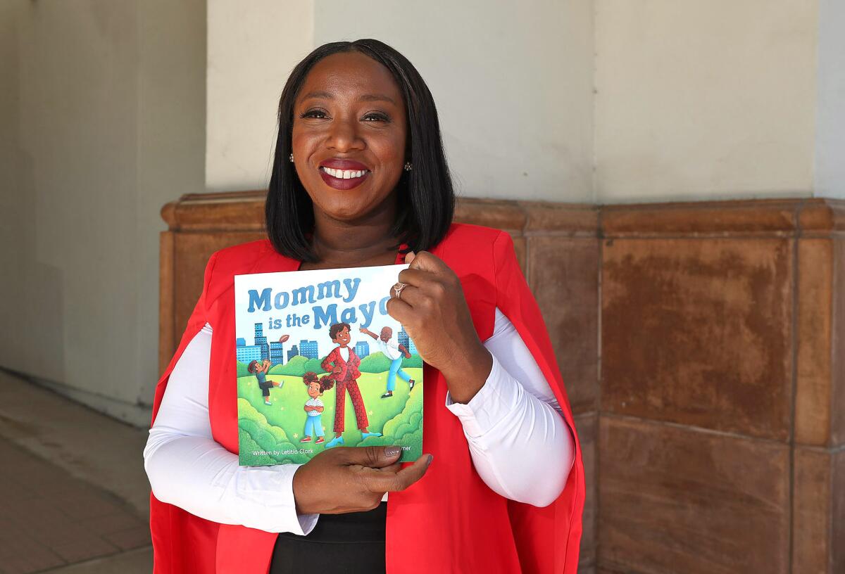 Letitia Clark, mayor of Tustin holds her children's book "Mommy is the Mayor." 