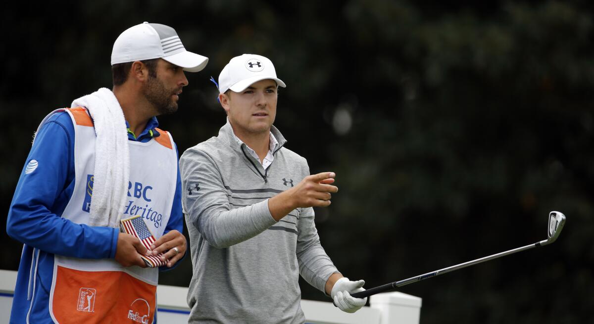 Jordan Spieth, right, talks with caddie Michael Greller on the 17th tee during the second round of the RBC Heritage golf tournamenton April 17, 2015.