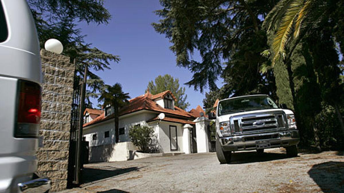 Vans carry jurors in the second murder trial of Phil Spector to the legendary music producer's mansion in Alhambra.