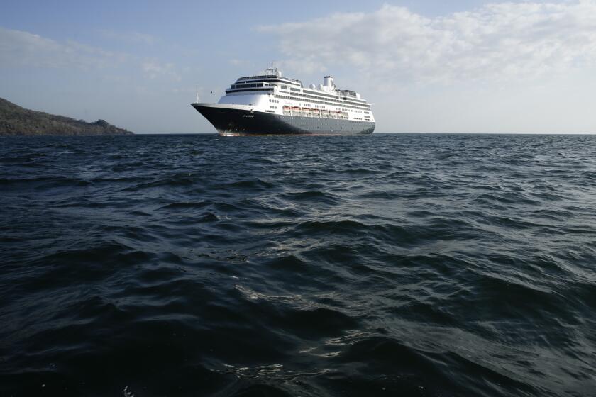 The Zaandam cruise ship is anchored in the bay of Panama City, Friday, March 27, 2020. Several passengers have died aboard the cruise ship and a few people aboard the ship have tested positive for the new coronavirus, the cruise line said Friday, with hundreds of passengers unsure how long they will remain at sea. (AP Photo/Arnulfo Franco)