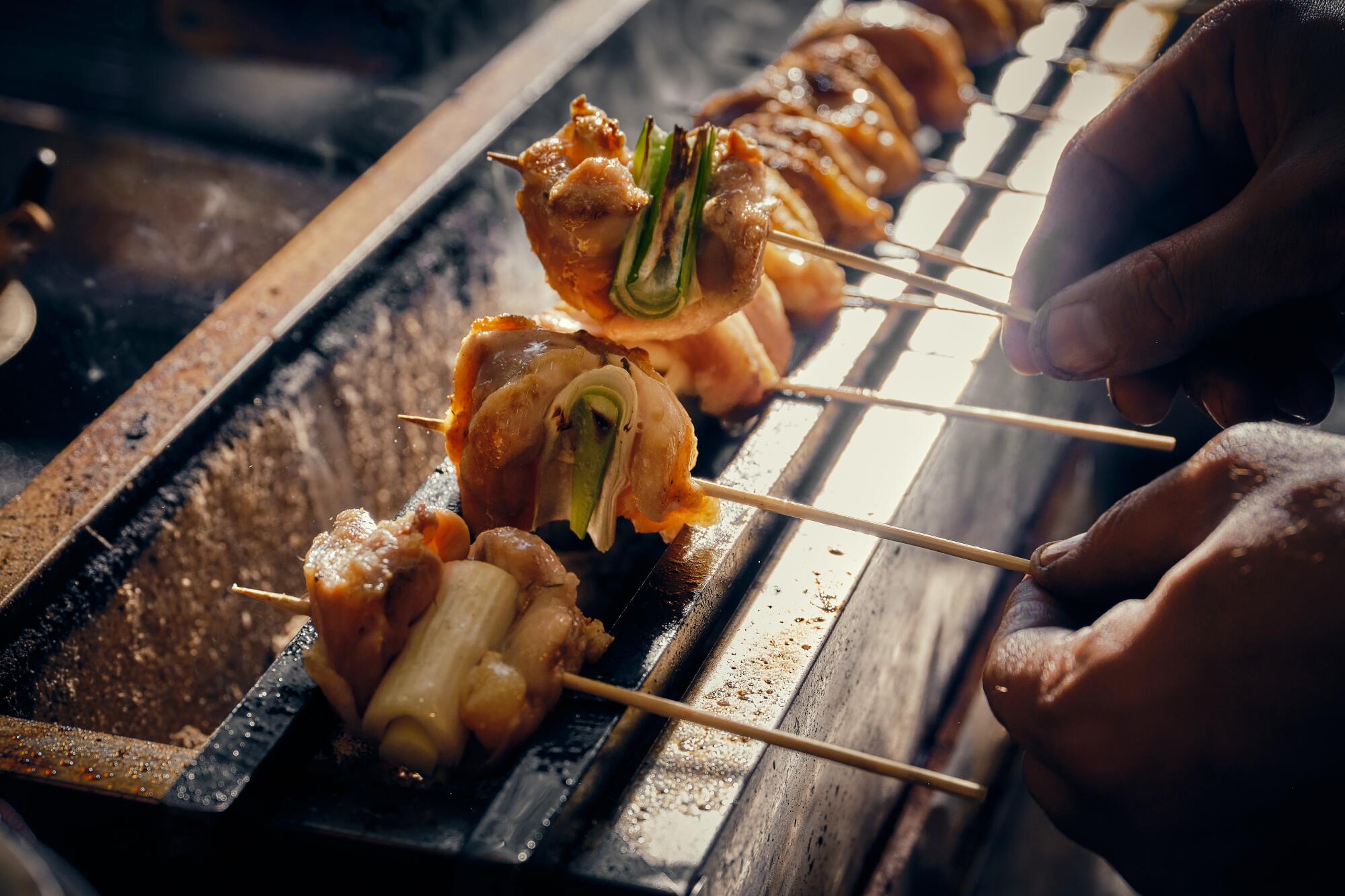 A like of skewers on a grill.