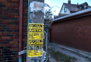 A poster for an immigrant justice rally taped to a pole