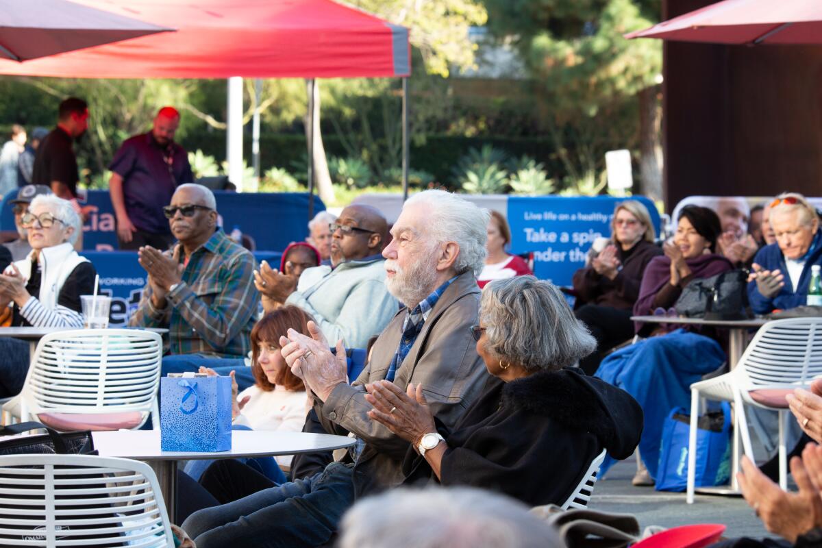 Veterans and military families enjoy an outdoor concert in the Julianne and George Argyros Plaza. 