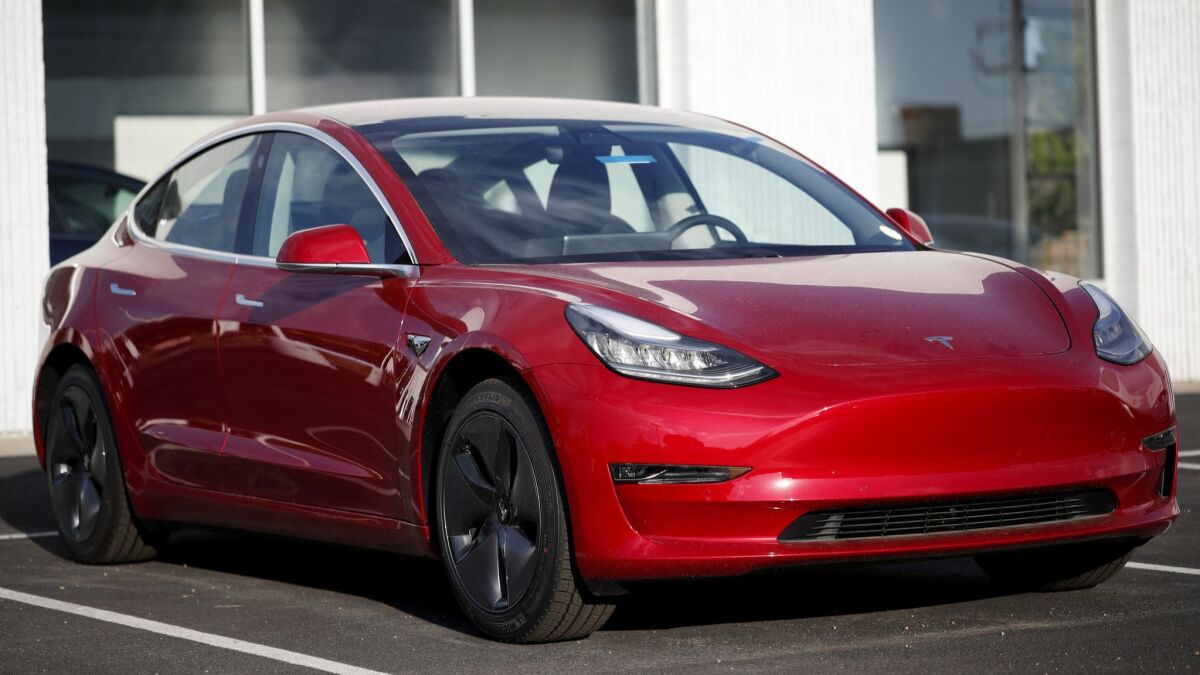 A Model 3 sedan sits at a Tesla dealership in Colorado in May.