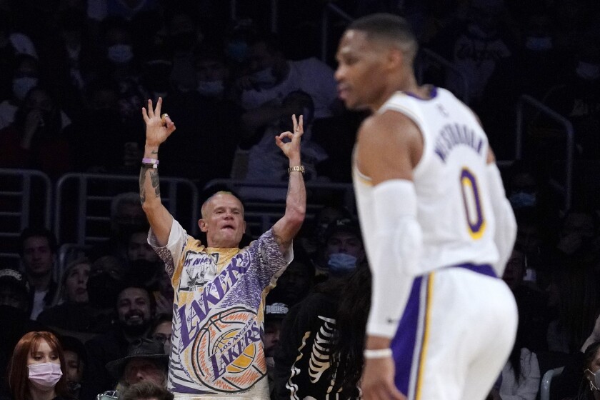 Red Hot Chili Peppers bassist Michael Balzary, known professionally as Flea, cheers after a Lakers basket.