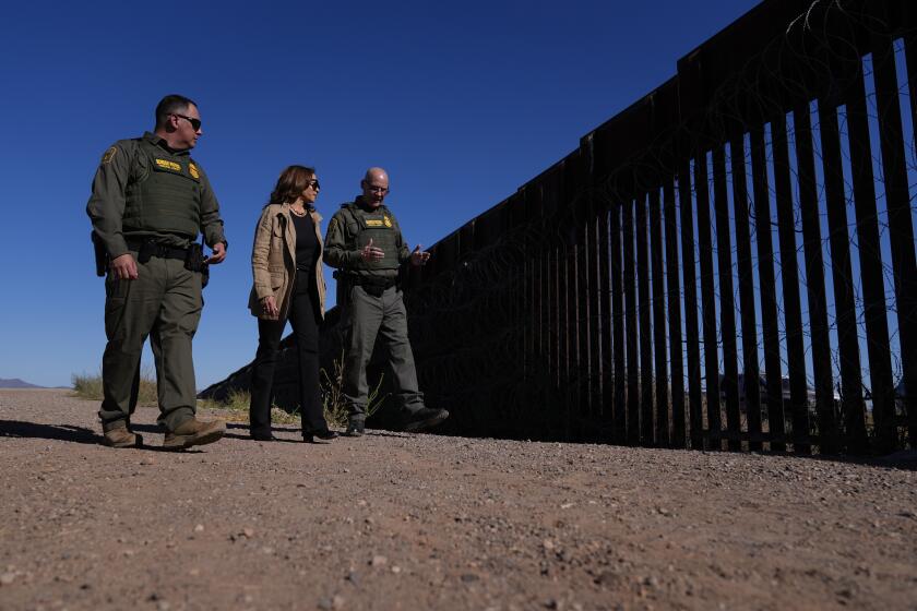 Democratic presidential nominee Vice President Kamala Harris talks with John Modlin, the chief patrol agent for the Tucson Sector of the U.S. Border Patrol, right, and Blaine Bennett, the U.S. Border Patrol Douglas Station border patrol agent in charge, as she visits the U.S. border with Mexico in Douglas, Ariz., Friday, Sept. 27, 2024. (AP Photo/Carolyn Kaster)