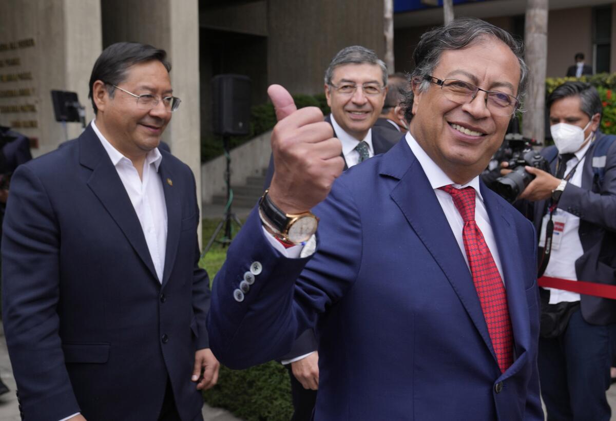 El presidente colombiano Gustavo Petro, a la derecha, levanta el pulgar
