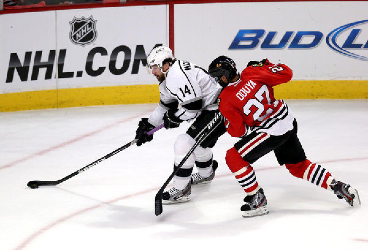 Kings' Justin Williams carries the puck past Chicago Blackhawks defenseman Johnny Oduya during the first period of Game 2.