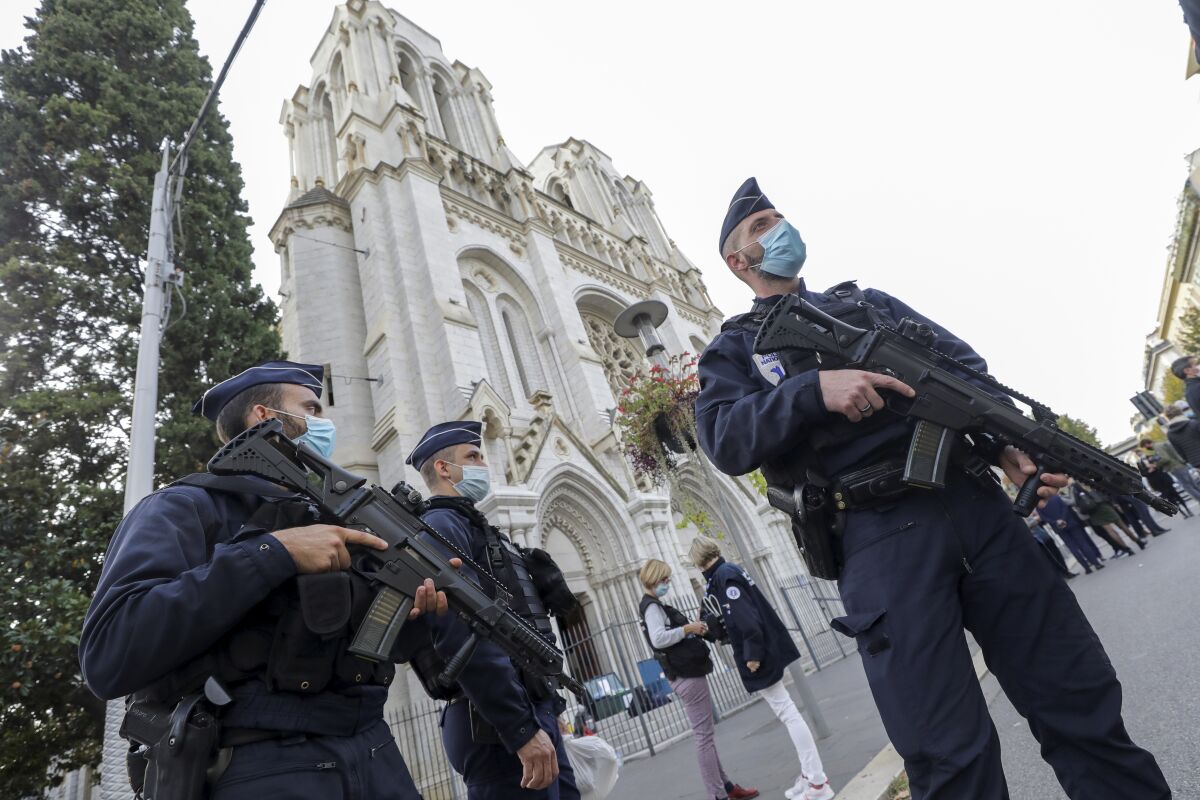 French police officers stand near the Notre Dame Church in Nice, southern France.