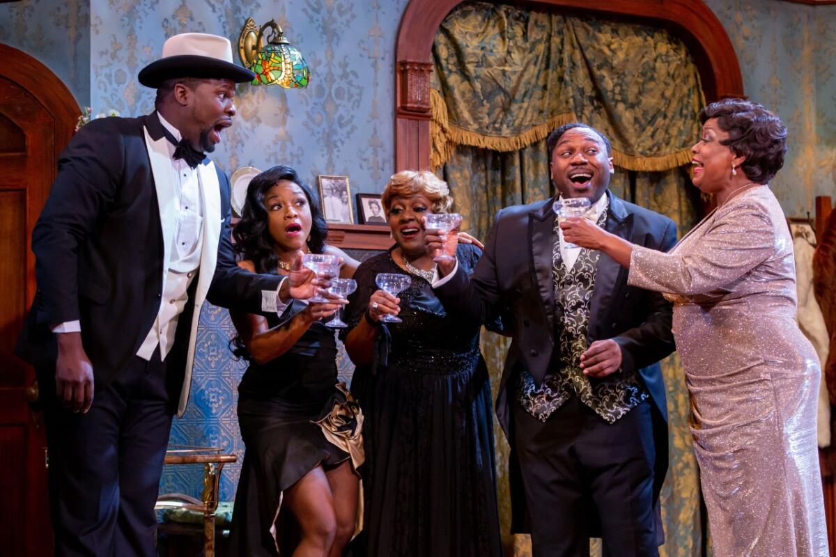 Five cast members of "Ain't Misbehavin'" toast with glasses in their hands.