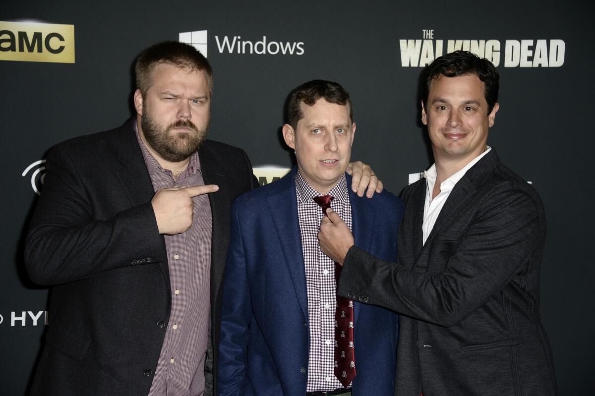 Executive producers, from left, Robert Kirkman, Scott M. Gimple and David Alpert arrive at the premiere of AMC's "The Walking Dead" fourth season at Universal CityWalk on October 3, 2013.