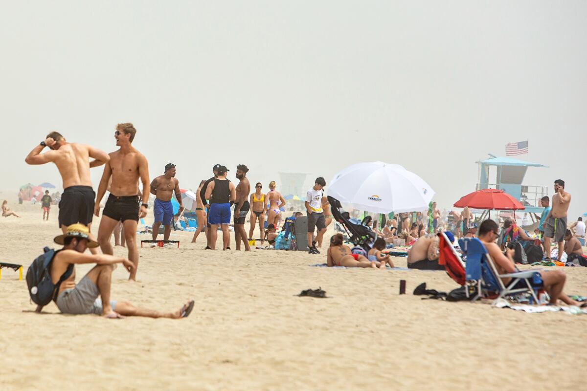 After being on lockdown for more than a month, people congregated Sunday at Huntington Beach.