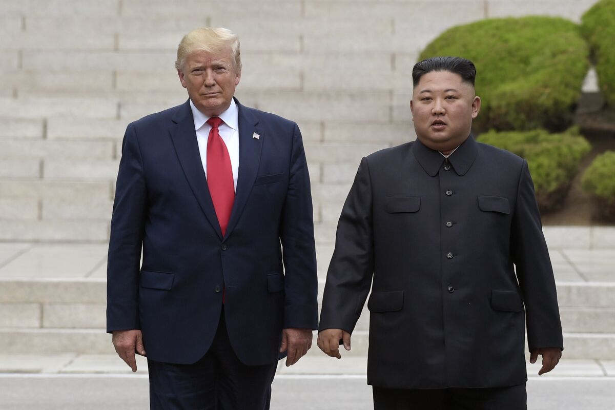 FILE - Then U.S. President Donald Trump, left, meets with North Korean leader Kim Jong Un at the North Korean side of the border at the village of Panmunjom in Demilitarized Zone, on June 30, 2019. Former President Trump has criticized the Biden administration over its handling of North Korea, insisting that the country's spree of missile tests in recent weeks wouldn’t have happened if he was still in office. Trump spoke in a recorded video message that was screened on Sunday, Feb. 13, 2022, at a church forum. (AP Photo/Susan Walsh, File)