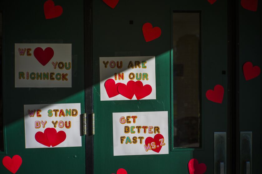 FILE - Messages of support for teacher Abby Zwerner, who was shot by a 6-year-old student, grace the front door of Richneck Elementary School Newport News, Va. on Jan. 9, 2023. Zwerner said Monday, March 20, that she has had four surgeries and has gone through a challenging recovery. (AP Photo/John C. Clark, File)