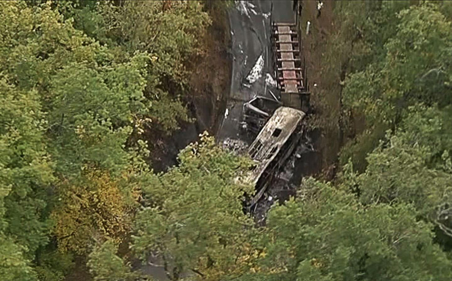 This video grab taken from French TV news channel BFM TV shows the wreckage of a coach carrying elderly retirees that collided with a truck, killing 42 people near the village of Puisseguin, France.