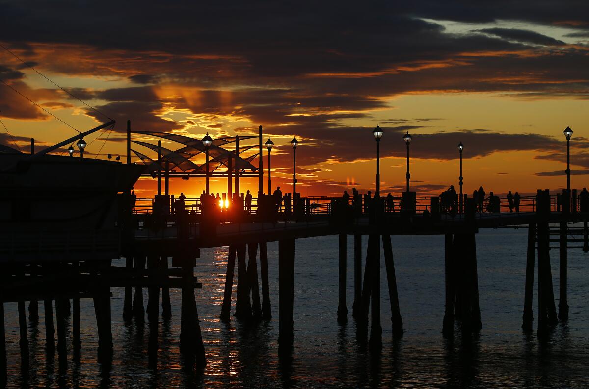 People watch the sunset at the Redondo Beach Pier on Dec. 30. 