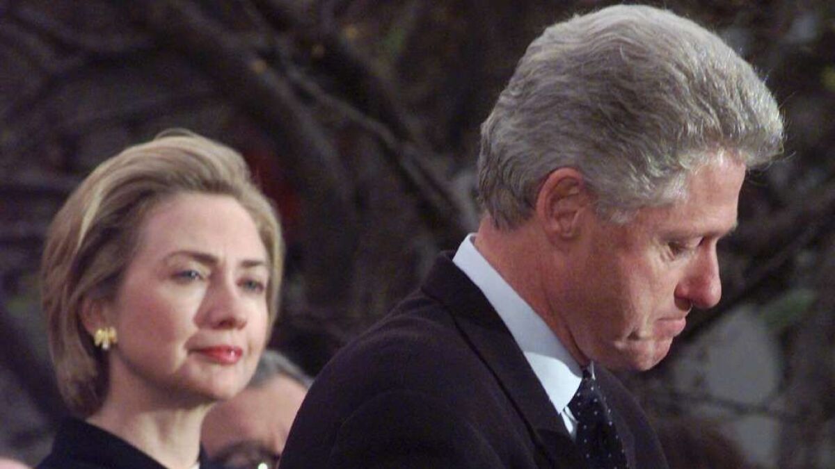 President Clinton makes a statement as first lady Hillary Rodham Clinton looks on at the White House.
