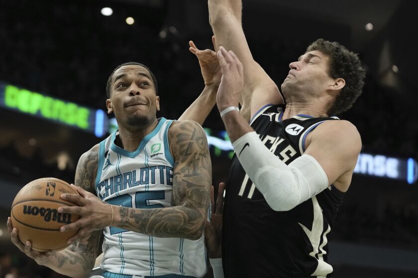 Charlotte Hornets' P.J. Washington tries to shoot past Milwaukee Bucks' Brook Lopez during the first half of an NBA basketball game Tuesday, Jan. 31, 2023, in Milwaukee. (AP Photo/Morry Gash)